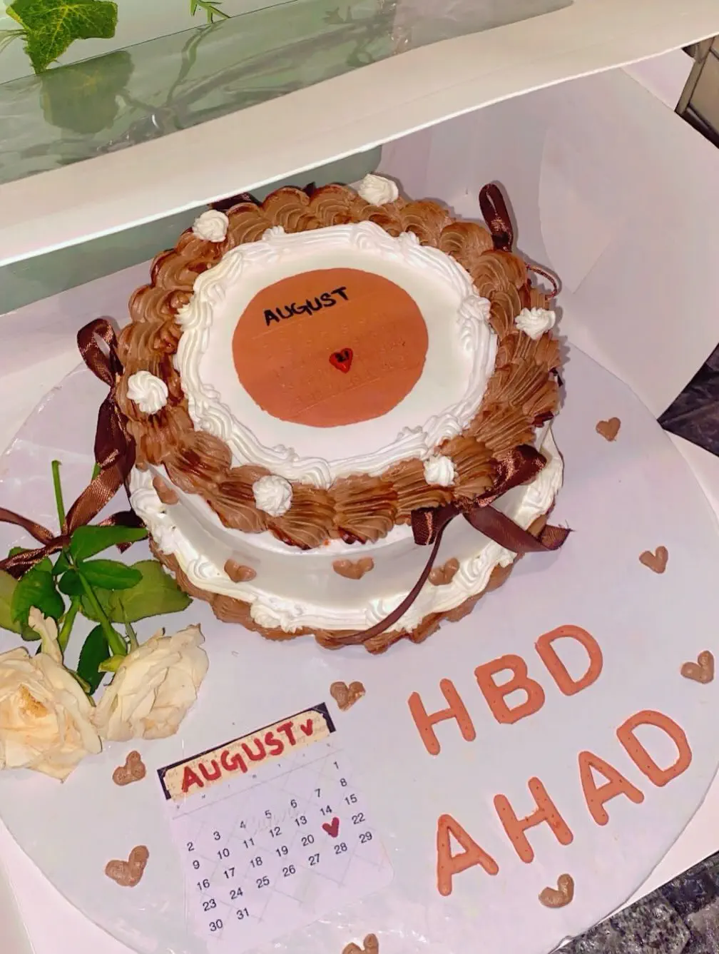 ed custom birthday cake for Ahad by Whisk And Sift featuring floral frosting white pearls and gold accents