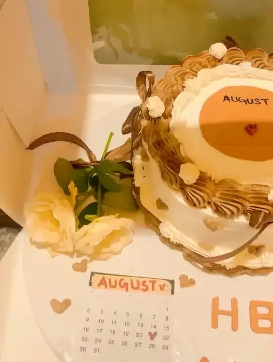Elegant red custom birthday cake decorated with piped frosting flowers and personalized Ahad message