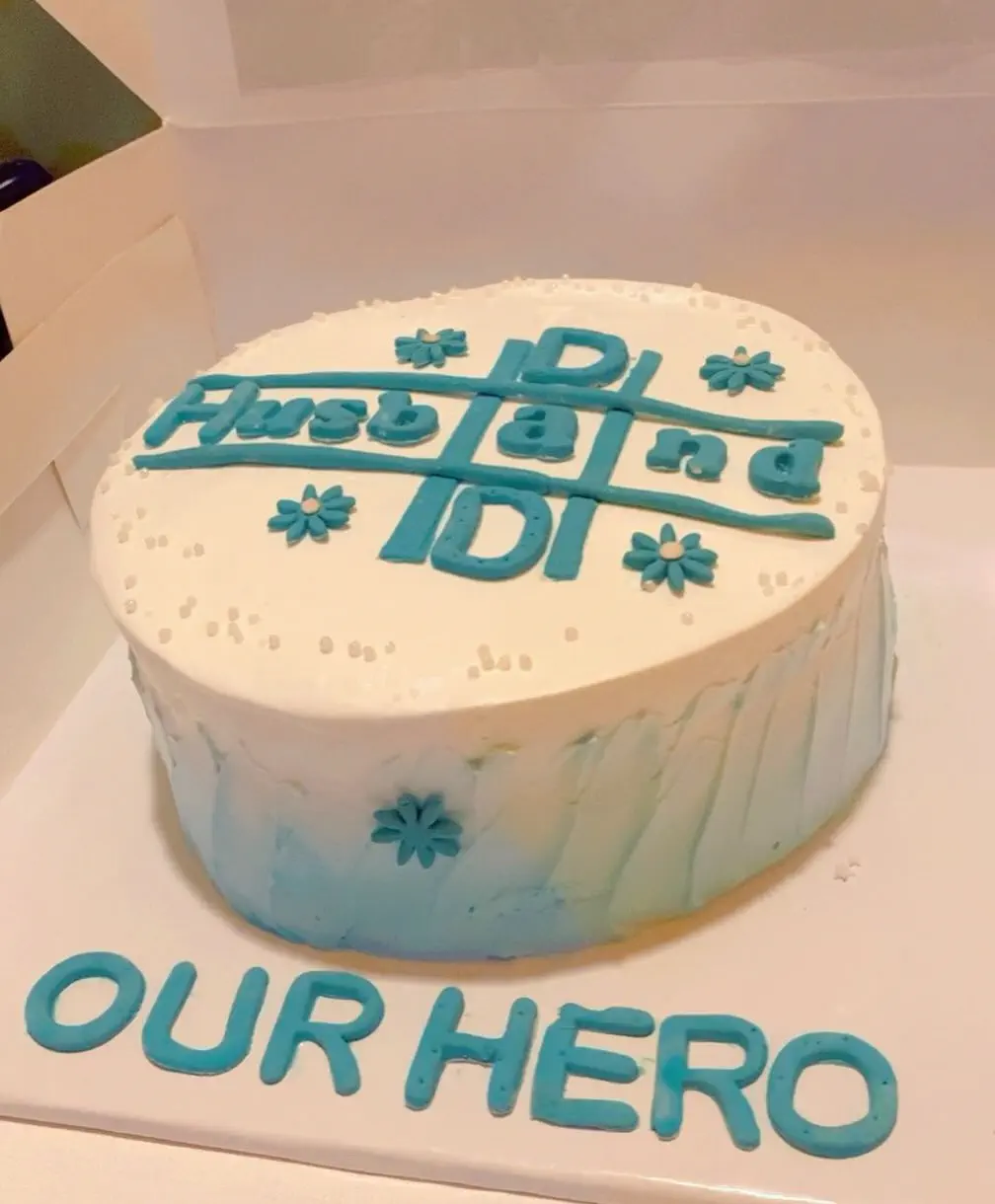 Custom Husband and Dad celebration cake by Whisk And Sift, featuring blue floral details on white frosting